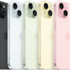 An array of iPhone 15 smartphones in various colors including black, white, gold, silver, and pink.