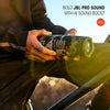Person holding a JBL flip 7 speaker with outdoor scenery 