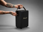 ​"Marshall Tufton portable speaker with a rugged build, textured black finish, and gold-tone control knobs on the top panel."